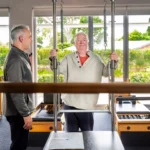 Instructor working with elderly client