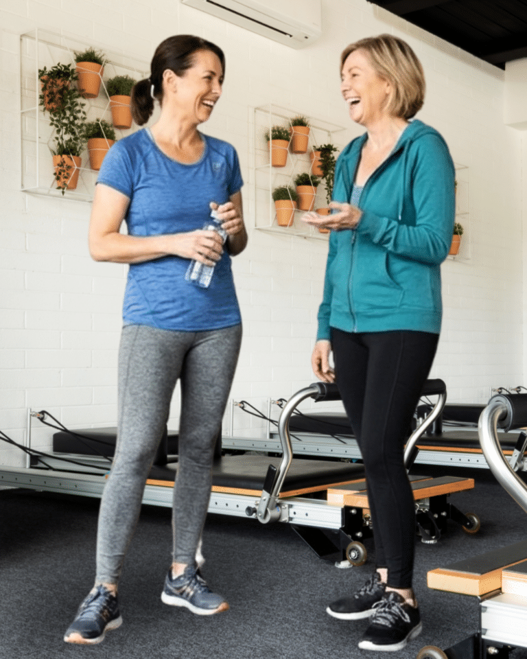 women chatting happily after a Pilates reformer class in MacLeod